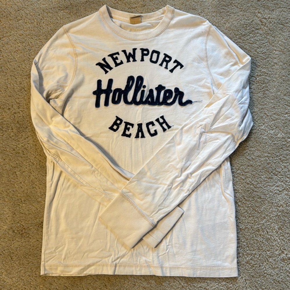 Men’s cream colored shirts with blue lettering
